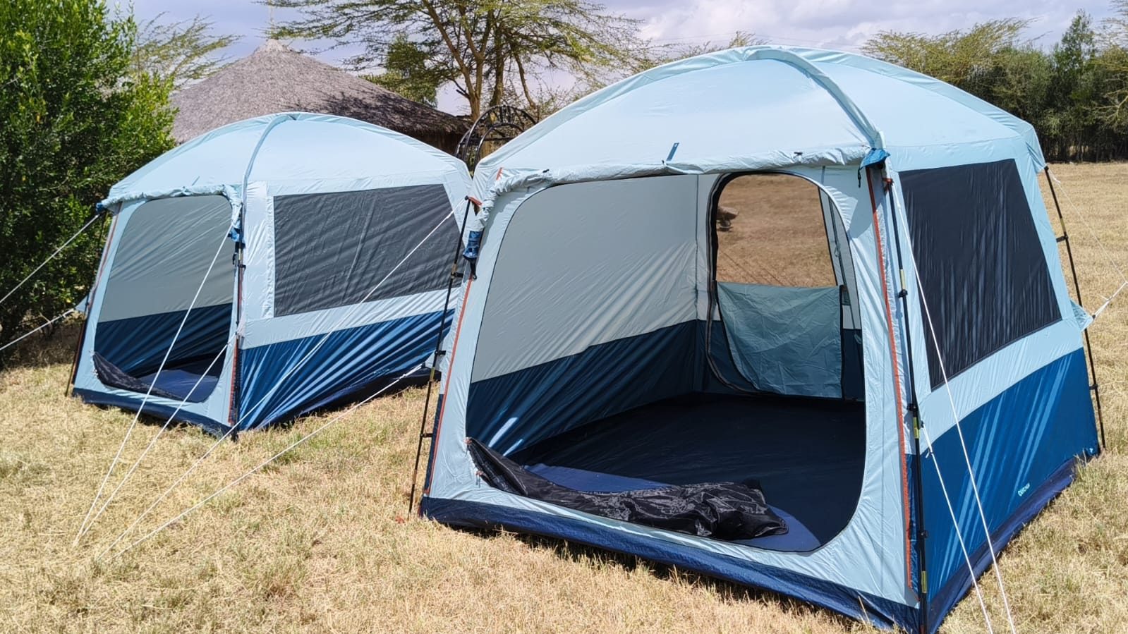 Spacious blue family dome tents open to the Mara evening