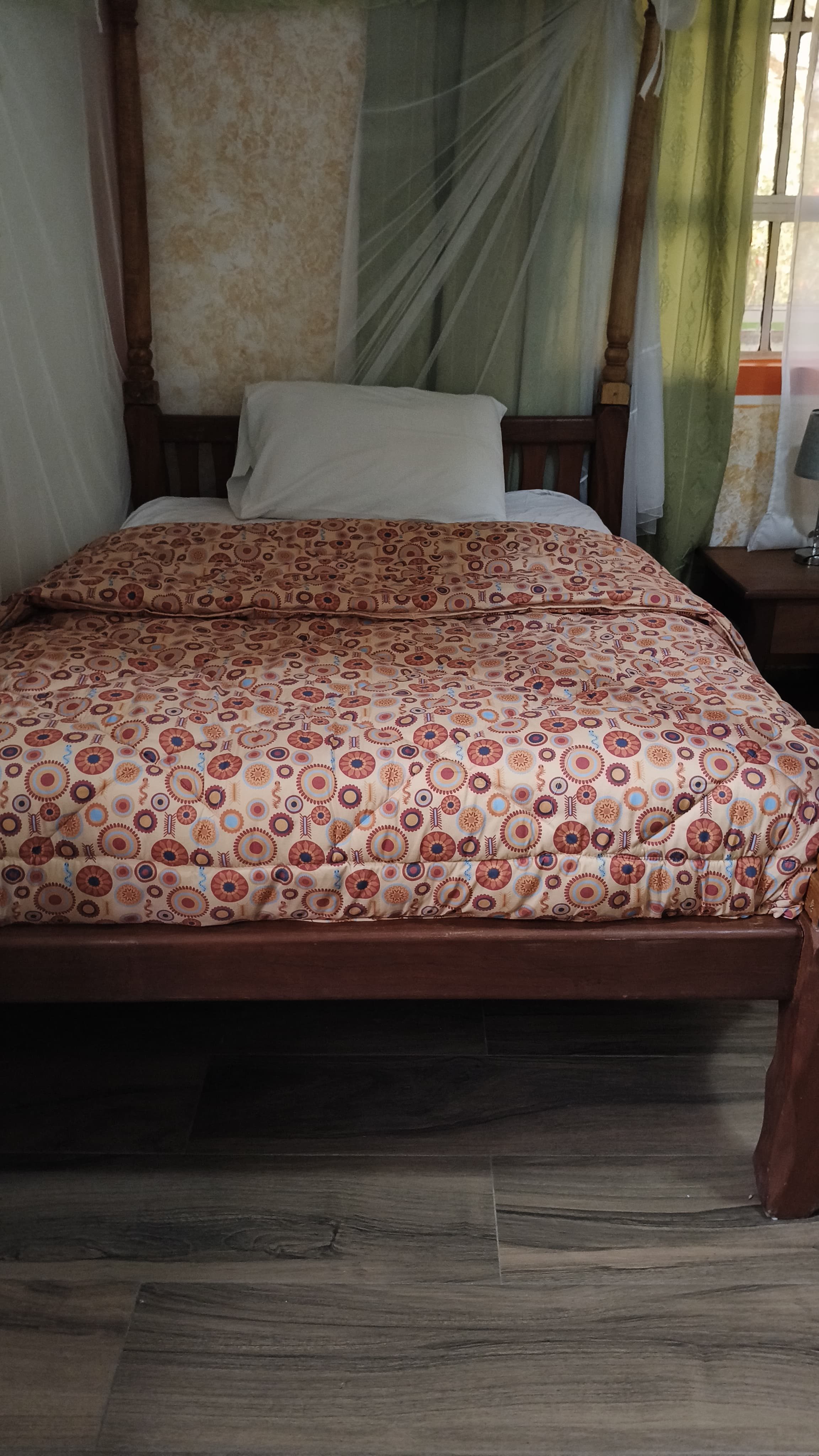 Guest house single room with a warm bedspread and bedside table